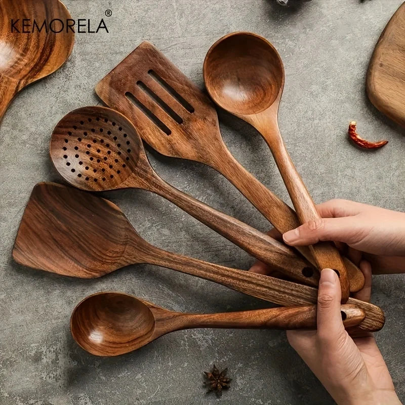 Cinq ustensiles de cuisine en teck KEMORELA tenus en main